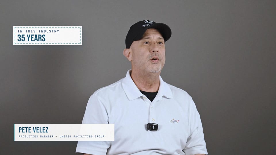 Pete Velez speaking in a black UFG cap and white polo, a frame from the film Thirty-Five Years With Al