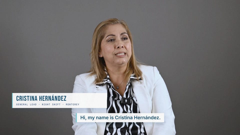 Cristina Hernandez smiling in a white blazer over a zebra-print blouse, a frame from the Spanish film On the Night Shift